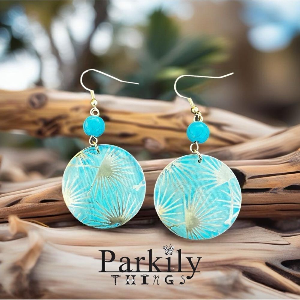 Patina metal earrings with a turquoise shade and gold on earwire